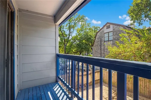 a view of a balcony with wooden floor