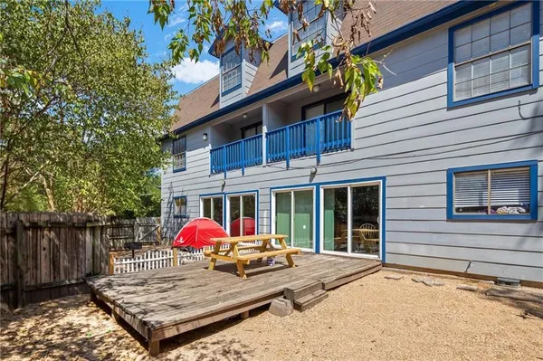 a view of a wooden house with a yard