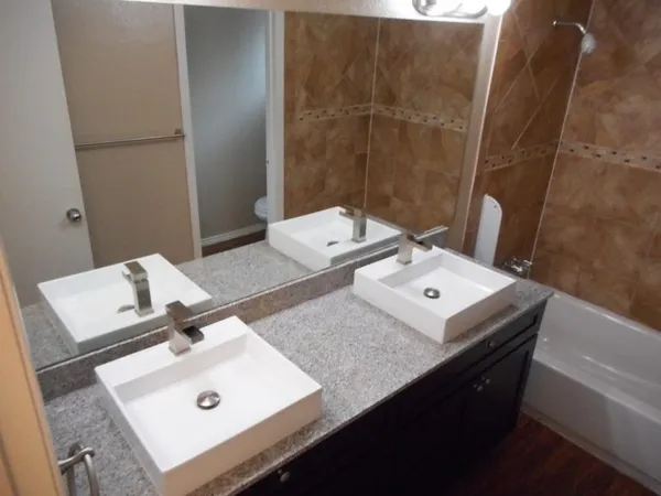 a bathroom with a sink vanity and a mirror