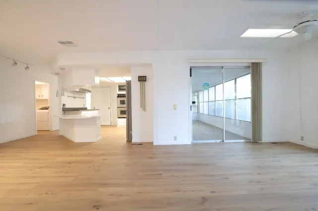 a view of a kitchen with a sink and a wooden floor