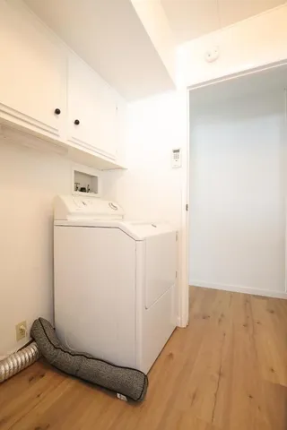 a view of a livingroom with wooden floor and a flat screen tv