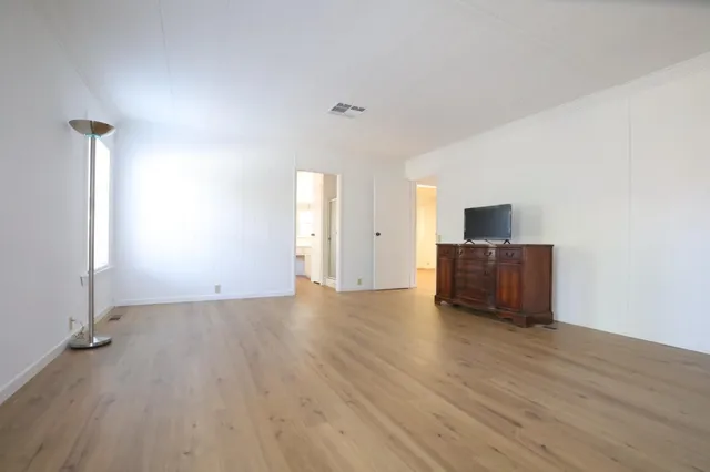 a spacious bathroom with a double vanity sink and a mirror