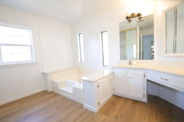 a en suite bathroom with a sink a mirror and shower