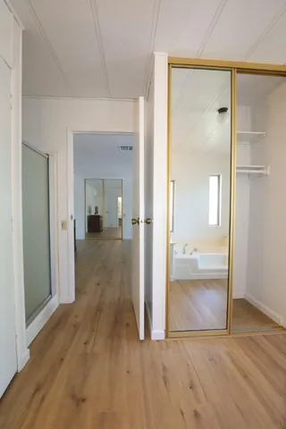 a view of room with window and wooden floor