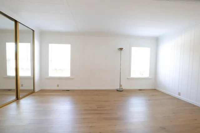 a view of a house with wooden fence
