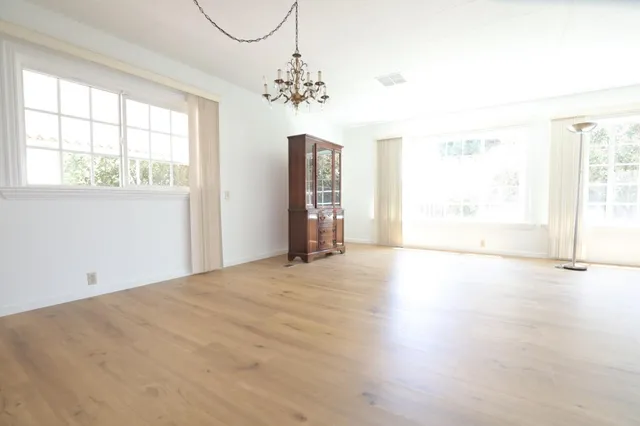 a balcony with wooden floor in front of it