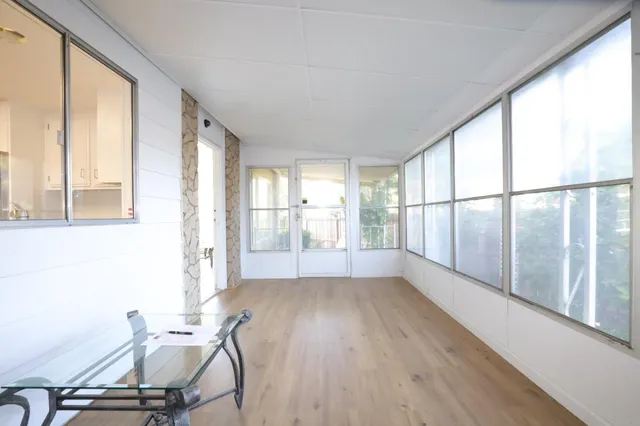 a view of backyard with swimming pool and sitting area