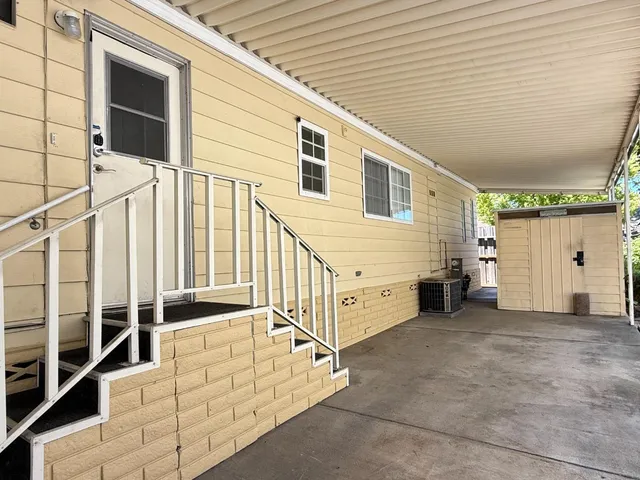 a view of a backyard with chair and tables