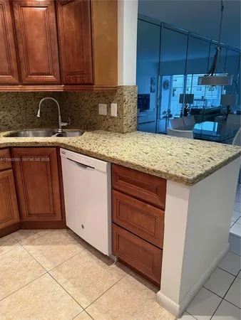a kitchen with stainless steel appliances granite countertop a sink and cabinets