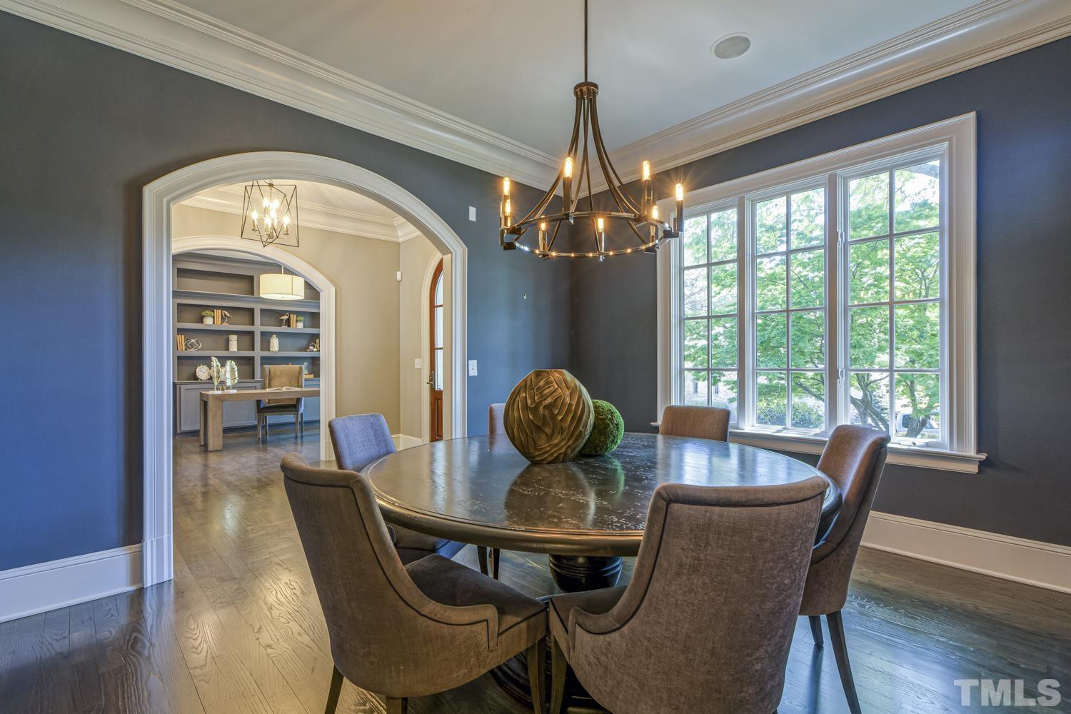 2642 Churchill Road Raleigh, NC 27608 - Photo 14 of 98 a view of a dining room with furniture wooden floor and chandelier