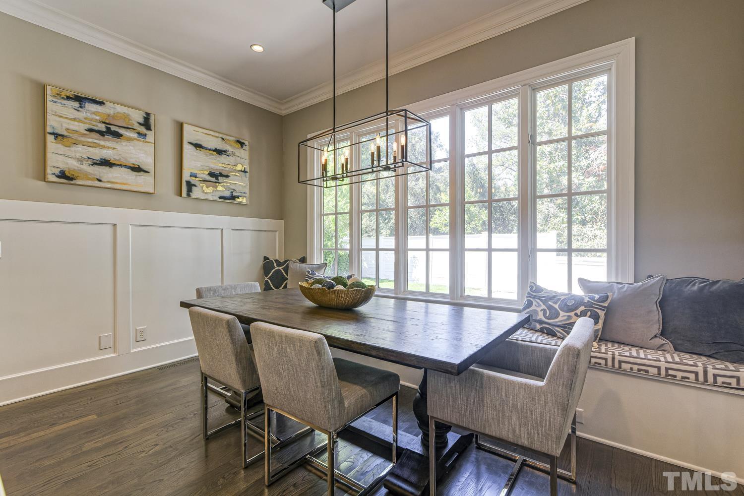 2642 Churchill Road Raleigh, NC 27608 - Photo 25 of 98 a view of a dining room with furniture window and wooden floor