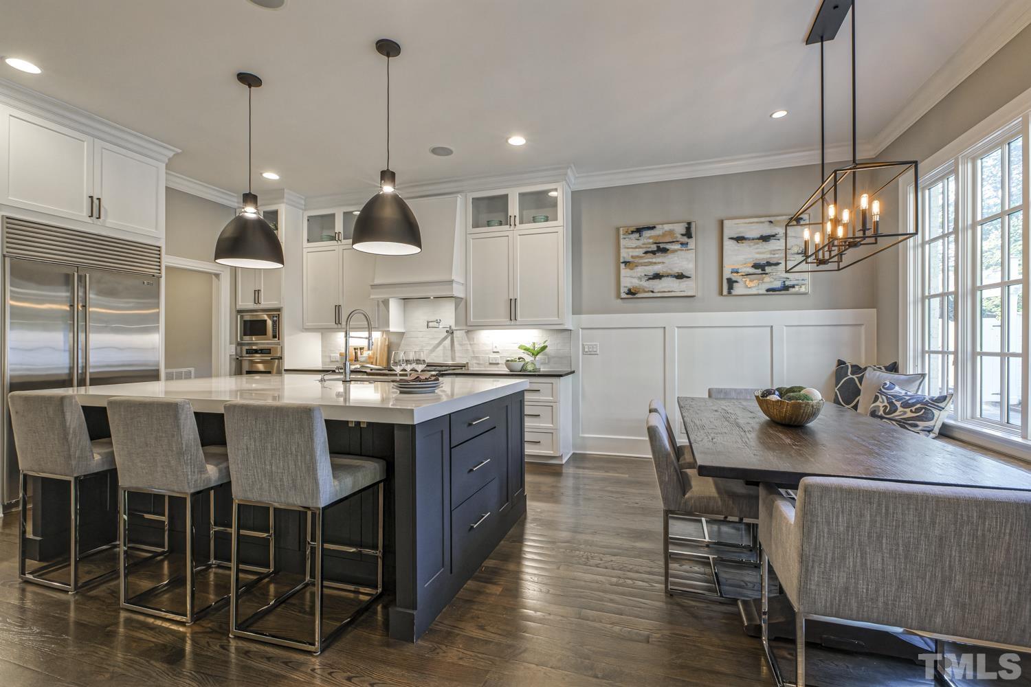 2642 Churchill Road Raleigh, NC 27608 - Photo 26 of 98 a room with stainless steel appliances kitchen island granite countertop a table chairs and a kitchen view