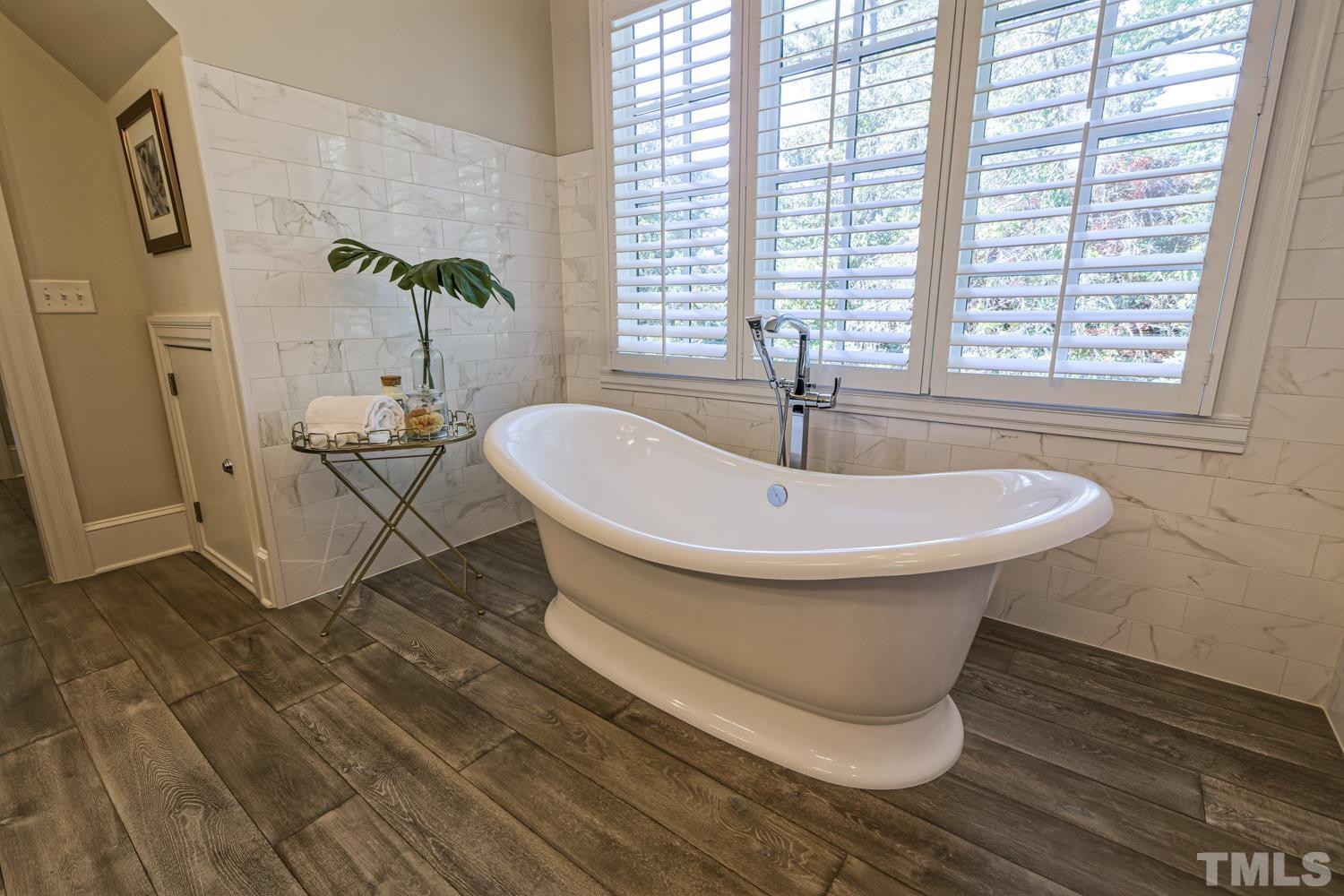 2642 Churchill Road Raleigh, NC 27608 - Photo 59 of 98 a bathroom with a sink and bathtub
