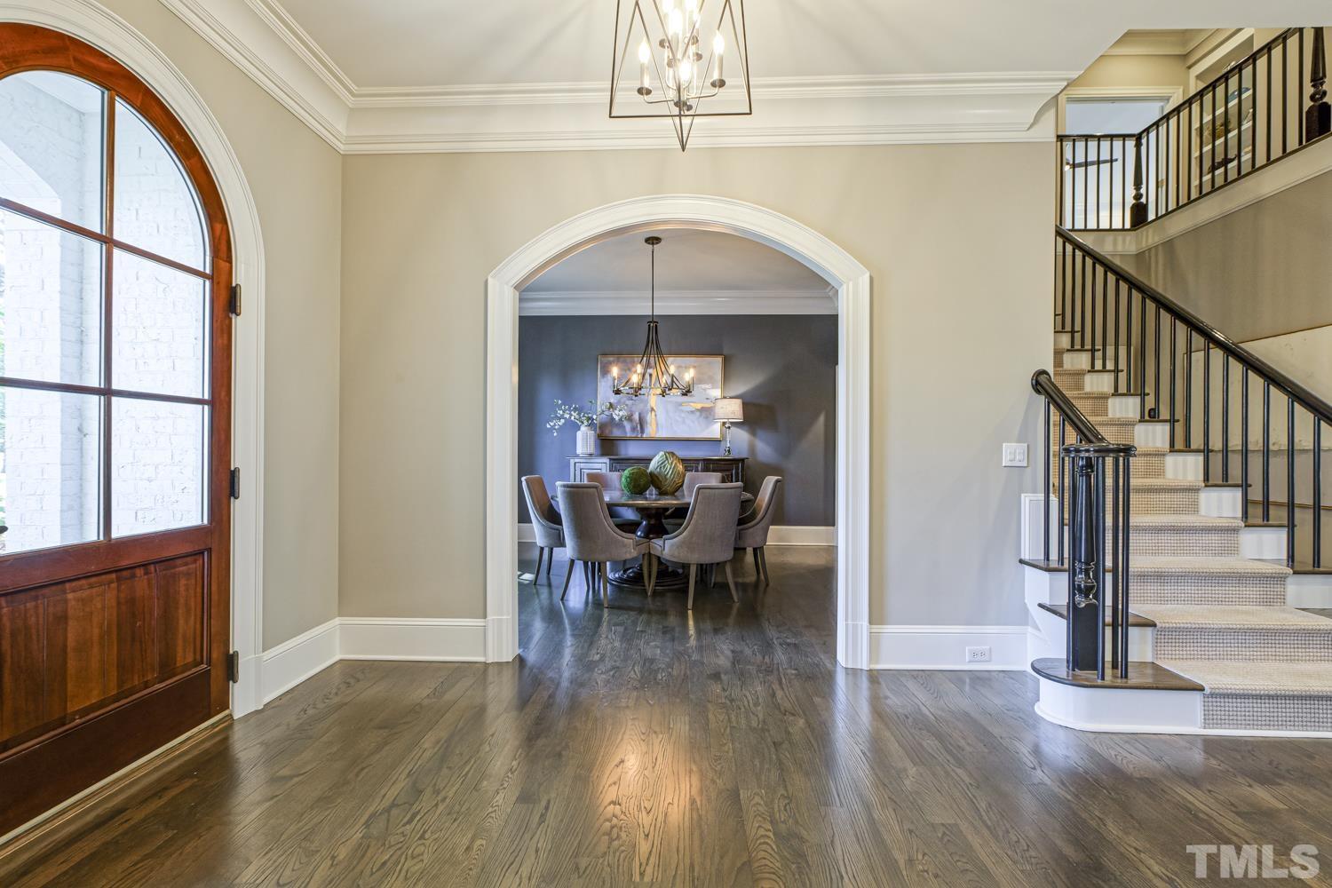 2642 Churchill Road Raleigh, NC 27608 - Photo 8 of 98 a view of a livingroom with furniture hardwood floor a ceiling fan and windows