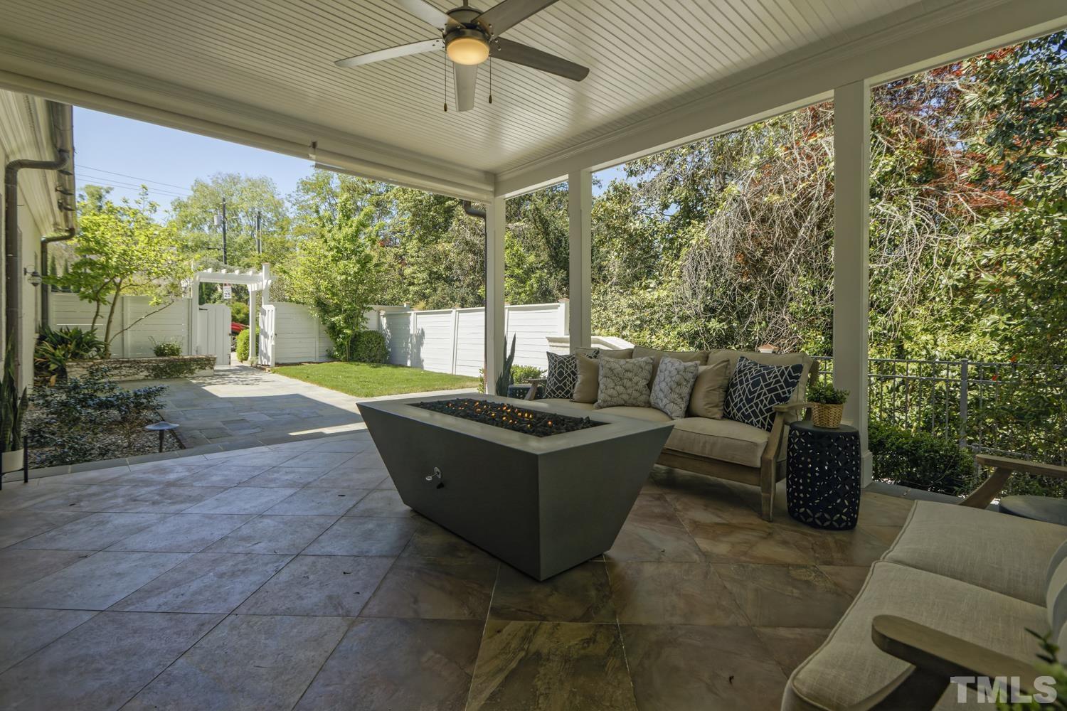 2642 Churchill Road Raleigh, NC 27608 - Photo 88 of 98 a living room with patio furniture and a floor to ceiling window