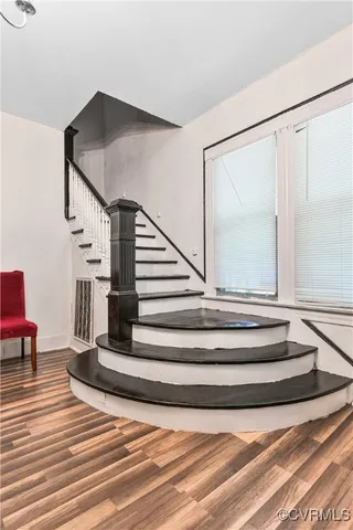 a view of entryway and hall with wooden floor