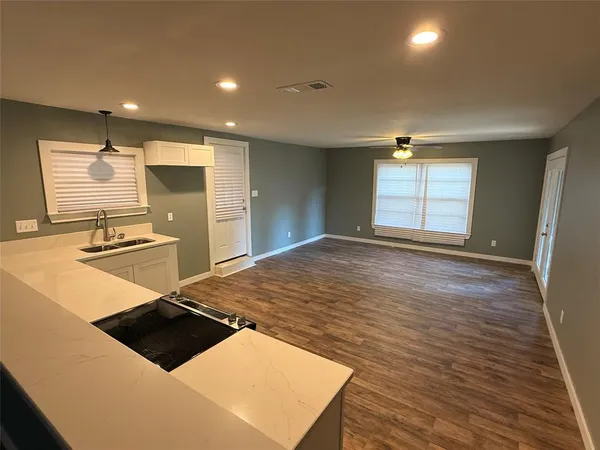 a view of kitchen with kitchen island microwave and stove