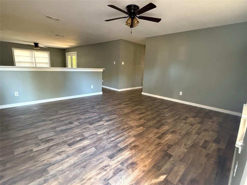 606 Colonial Drive Athens, TX 75751 - Photo 3 of 12 a view of a big room with wooden floor and windows