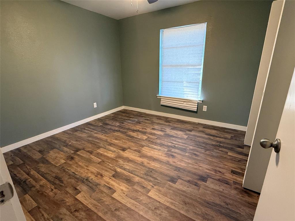 606 Colonial Drive Athens, TX 75751 - Photo 4 of 12 a view of room with window and hardwood floor