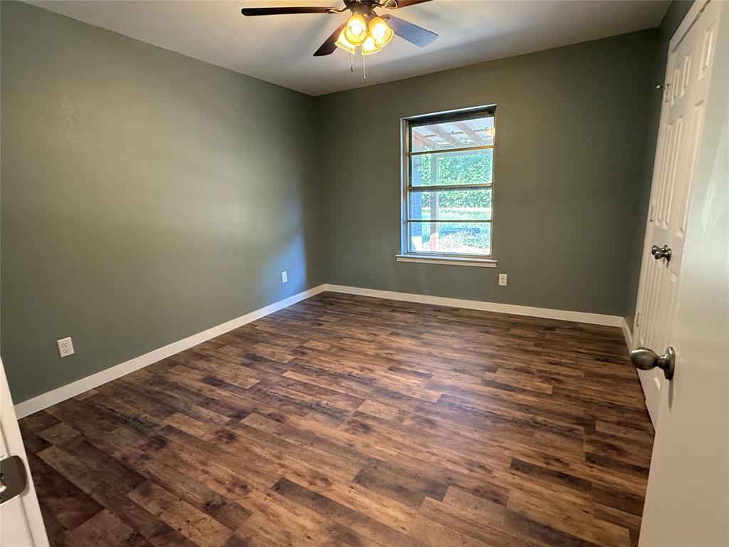 606 Colonial Drive Athens, TX 75751 - Photo 5 of 12 a view of a room with a ceiling fan and window