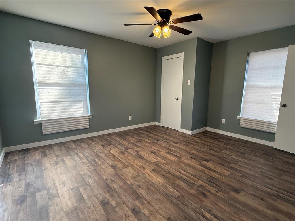 606 Colonial Drive Athens, TX 75751 - Photo 6 of 12 a view of an empty room with a window and wooden floor