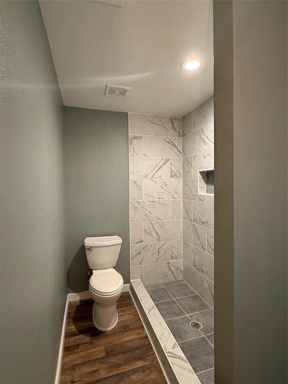 606 Colonial Drive Athens, TX 75751 - Photo 7 of 12 a bathroom with a toilet and a shower