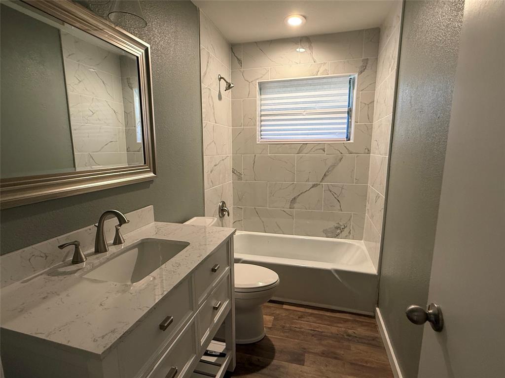 606 Colonial Drive Athens, TX 75751 - Photo 9 of 12 a bathroom with a granite countertop sink toilet and shower