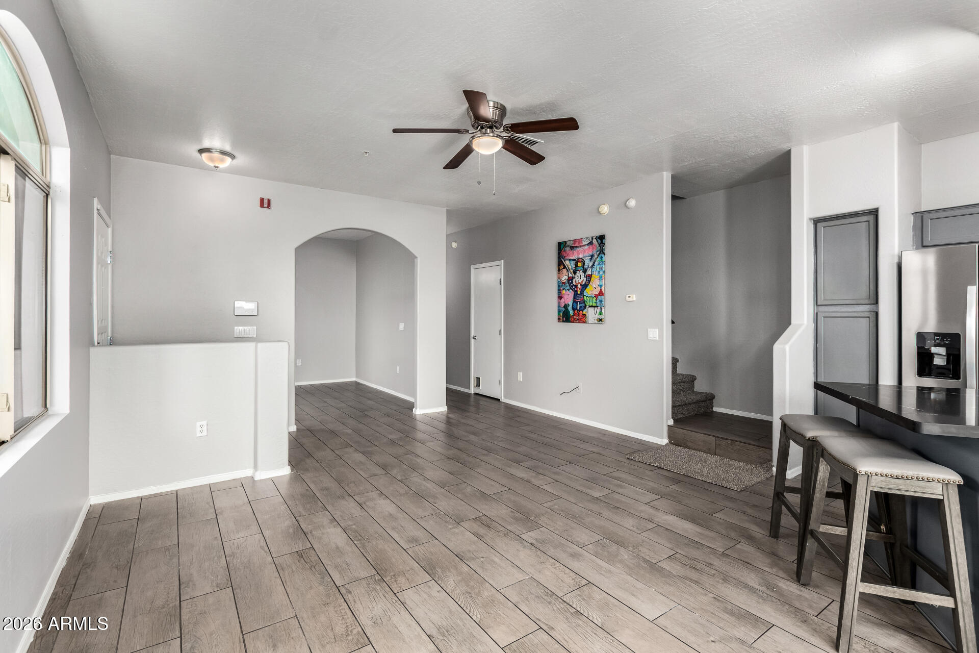 2150 East Bell Road, Unit 1075 Phoenix, AZ 85022 - Photo 11 of 45 a view of a livingroom with a furniture hardwood floor and a ceiling fan