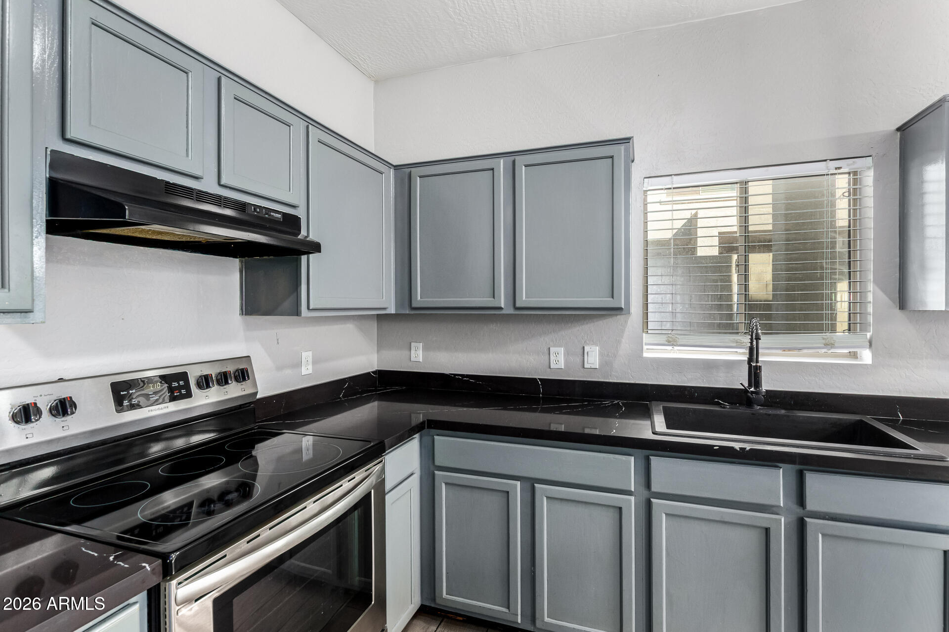 2150 East Bell Road, Unit 1075 Phoenix, AZ 85022 - Photo 14 of 45 a kitchen with a sink and cabinets