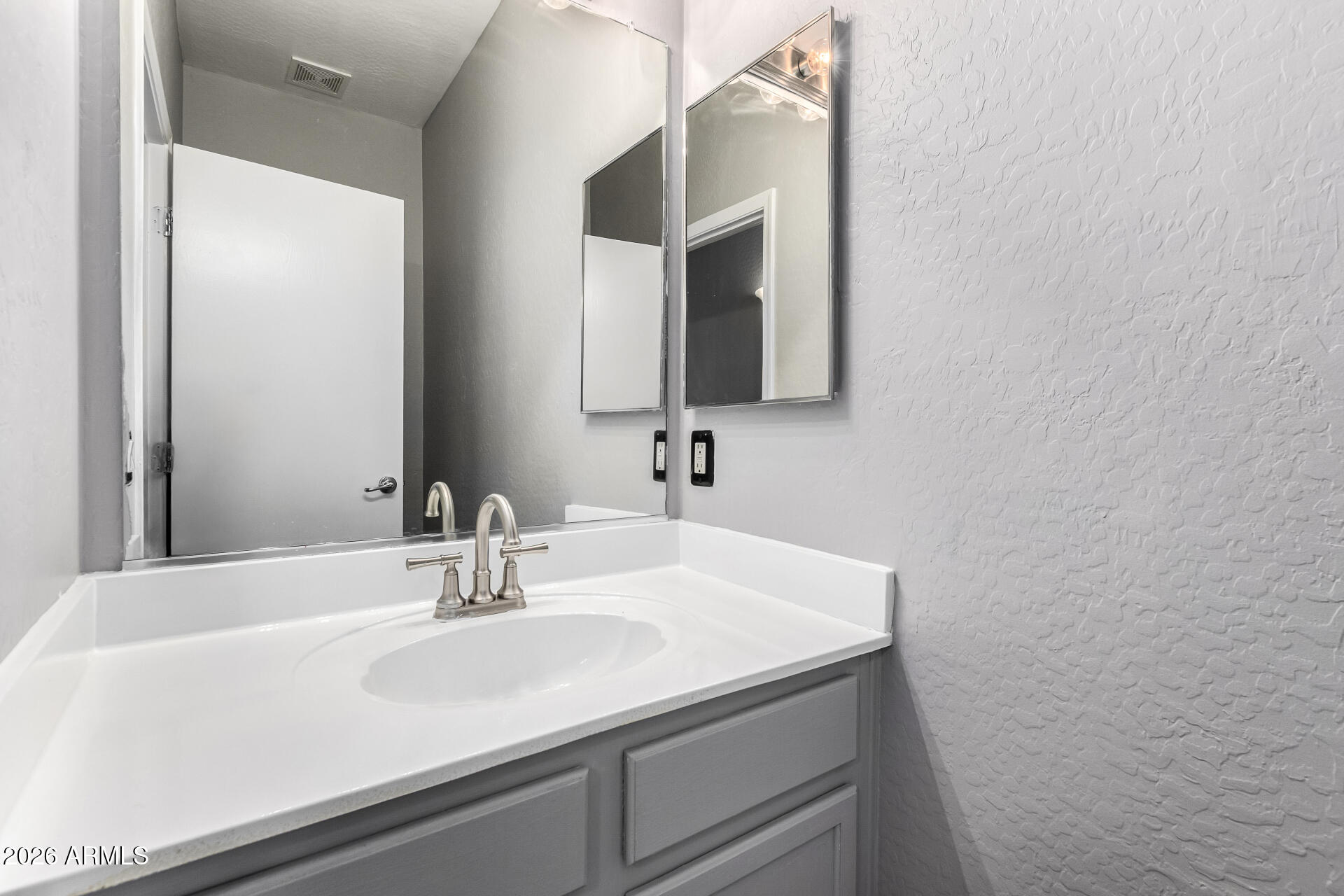 2150 East Bell Road, Unit 1075 Phoenix, AZ 85022 - Photo 15 of 45 a bathroom with a sink and a mirror