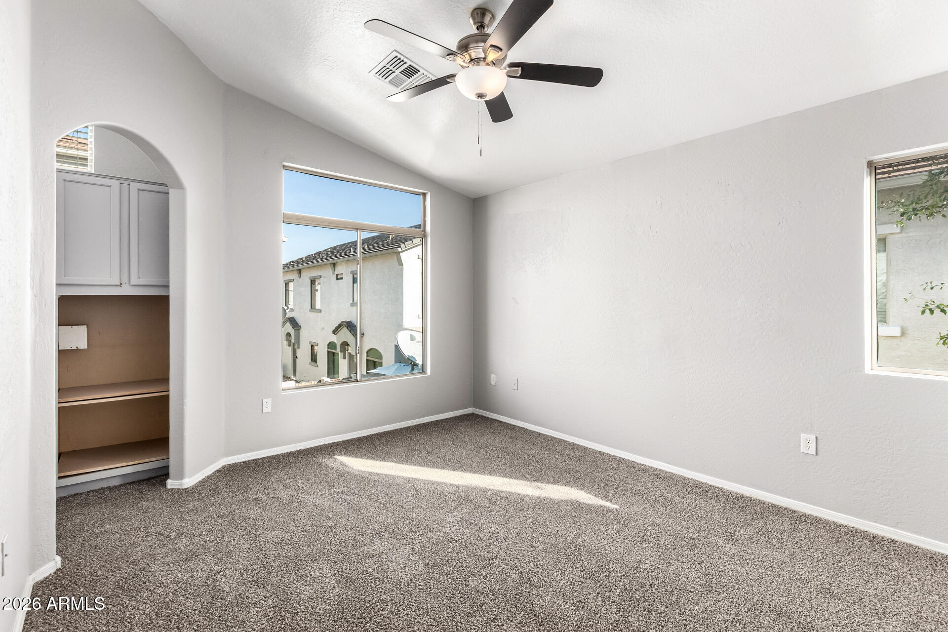 2150 East Bell Road, Unit 1075 Phoenix, AZ 85022 - Photo 17 of 45 an empty room with closet and windows