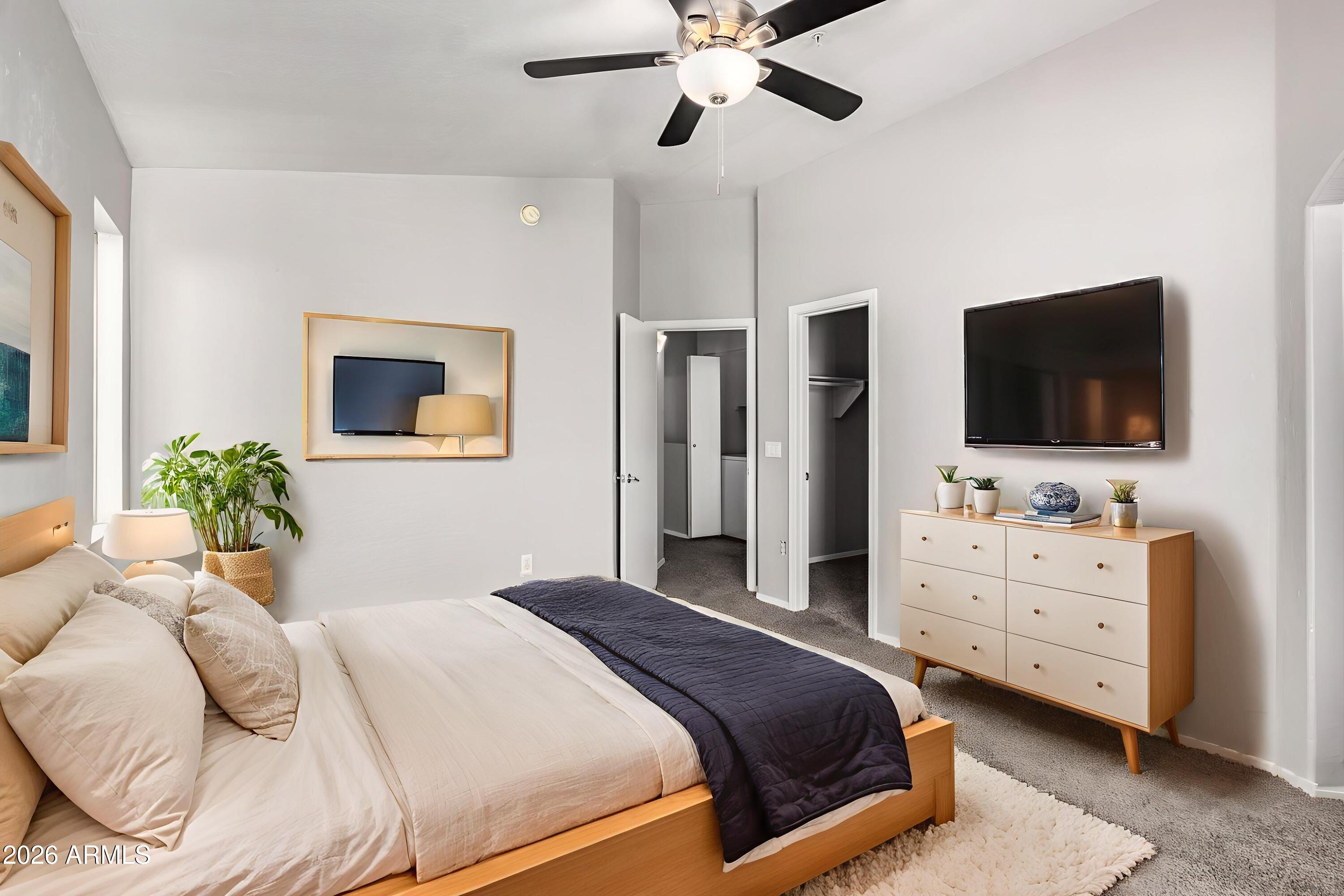 2150 East Bell Road, Unit 1075 Phoenix, AZ 85022 - Photo 18 of 45 a bedroom with a bed and a flat screen tv