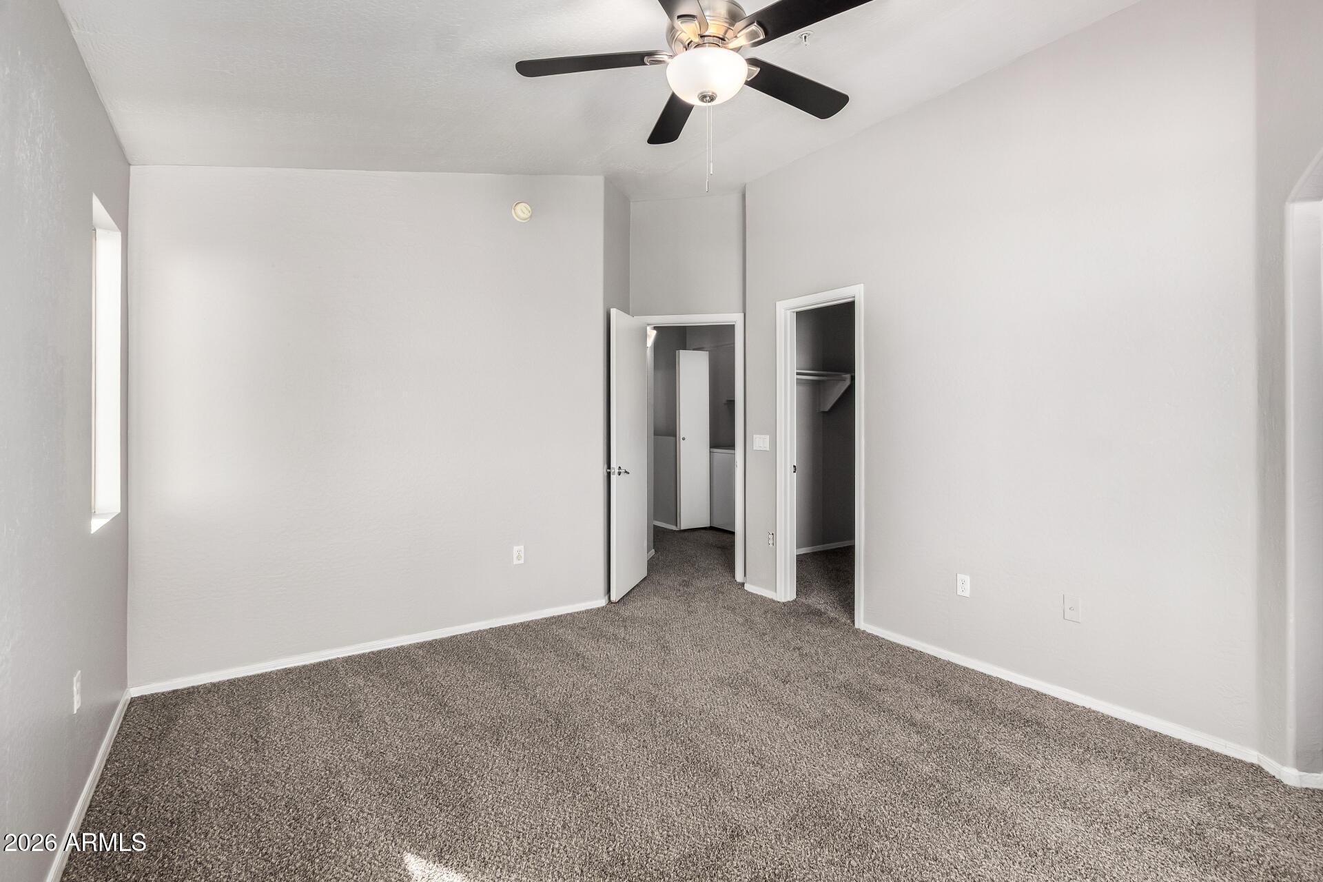 2150 East Bell Road, Unit 1075 Phoenix, AZ 85022 - Photo 19 of 45 a view of an empty room with a chandelier fan