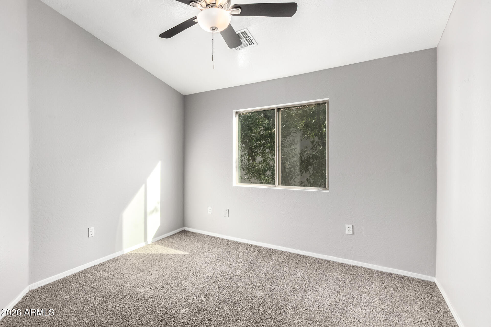 2150 East Bell Road, Unit 1075 Phoenix, AZ 85022 - Photo 28 of 45 an empty room with a window