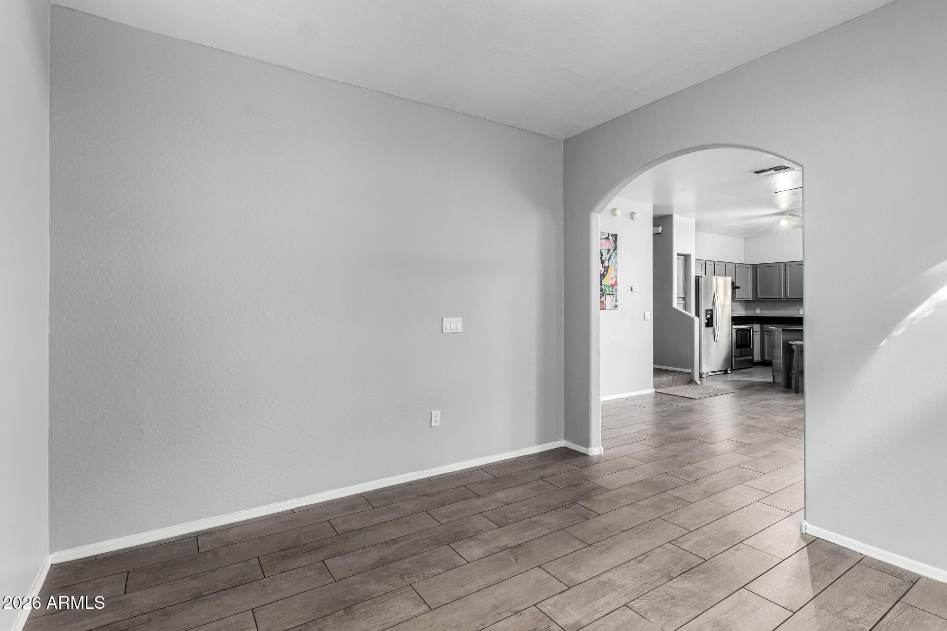 2150 East Bell Road, Unit 1075 Phoenix, AZ 85022 - Photo 32 of 45 a view of a hallway with wooden floor and a living room
