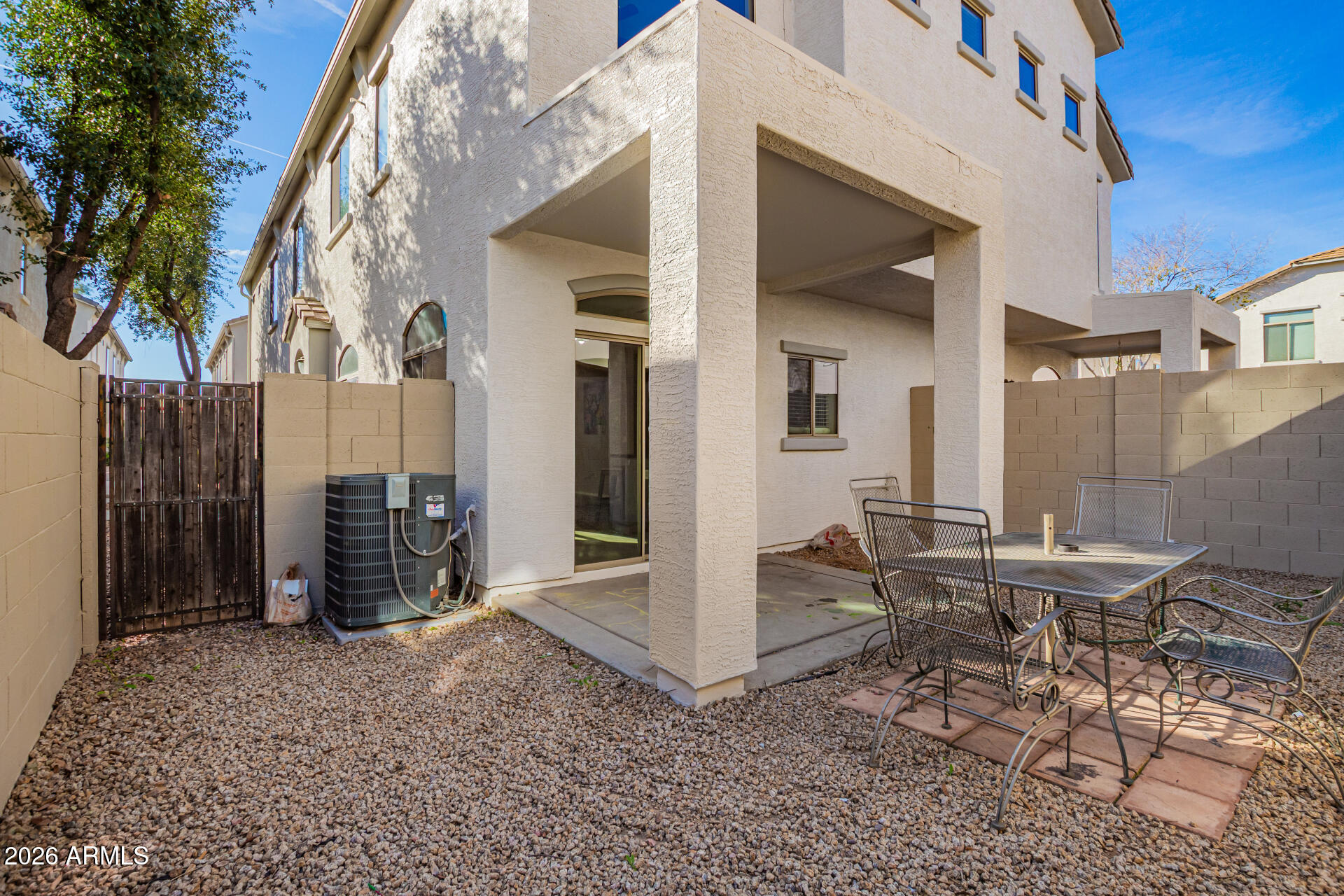 2150 East Bell Road, Unit 1075 Phoenix, AZ 85022 - Photo 37 of 45 a view of a patio with table and chairs and wooden fence