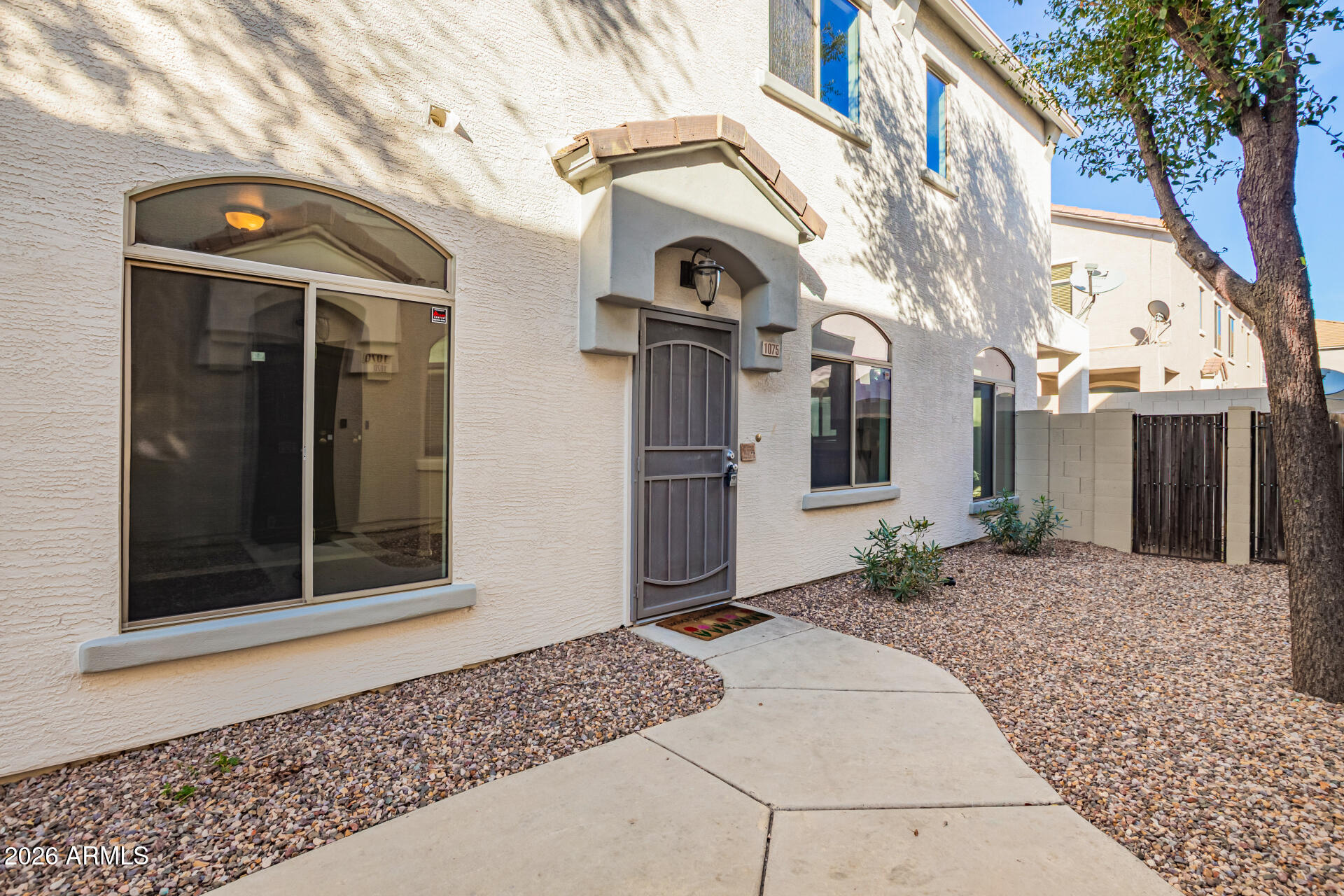 2150 East Bell Road, Unit 1075 Phoenix, AZ 85022 - Photo 5 of 45 a front view of a house with garden
