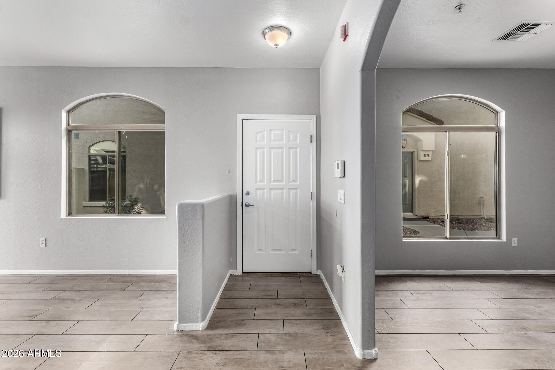 2150 East Bell Road, Unit 1075 Phoenix, AZ 85022 - Photo 6 of 45 a view of a hallway with windows and closet