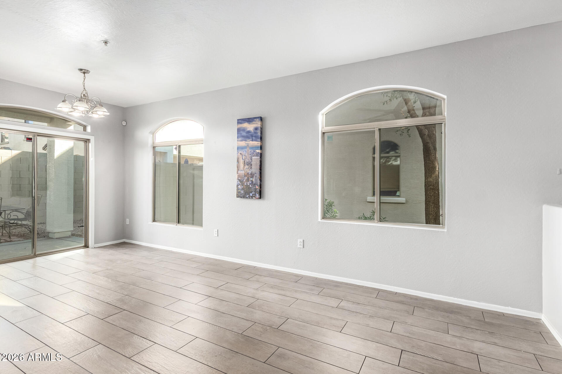 2150 East Bell Road, Unit 1075 Phoenix, AZ 85022 - Photo 8 of 45 a view of an empty room with glass door