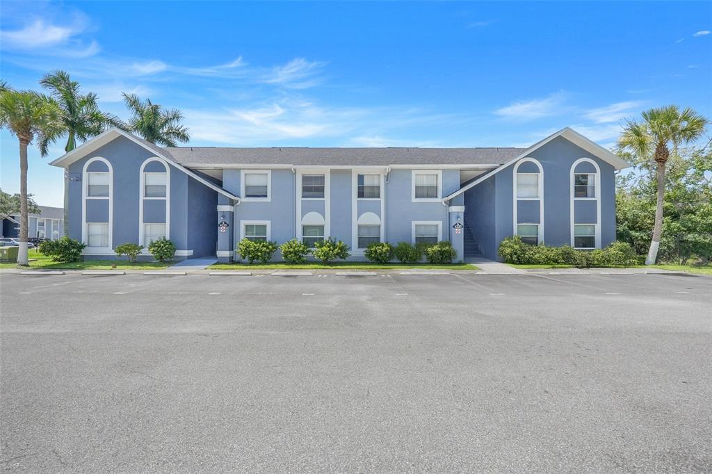 4226 Pershing Pointe Place, Unit 5 Orlando, FL 32822 - Photo 1 of 1 a front view of house with yard and green space