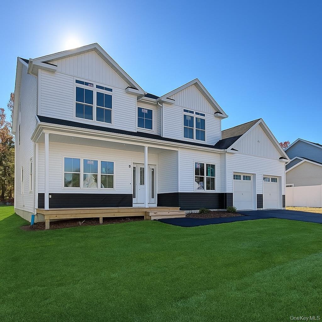 12 Fox Run Court Ridge, NY 11961 - Photo 2 of 11 a front view of a house with a yard