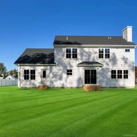 a front view of a house with a yard and that has window
