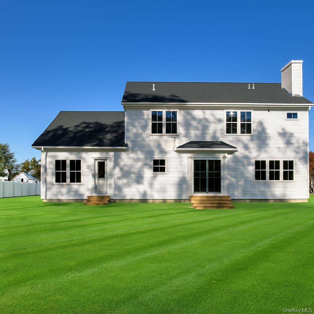 12 Fox Run Court Ridge, NY 11961 - Photo 3 of 11 a front view of a house with a yard and that has window