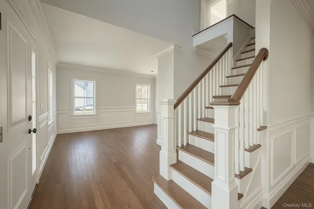 a view of an entryway with wooden floor and door