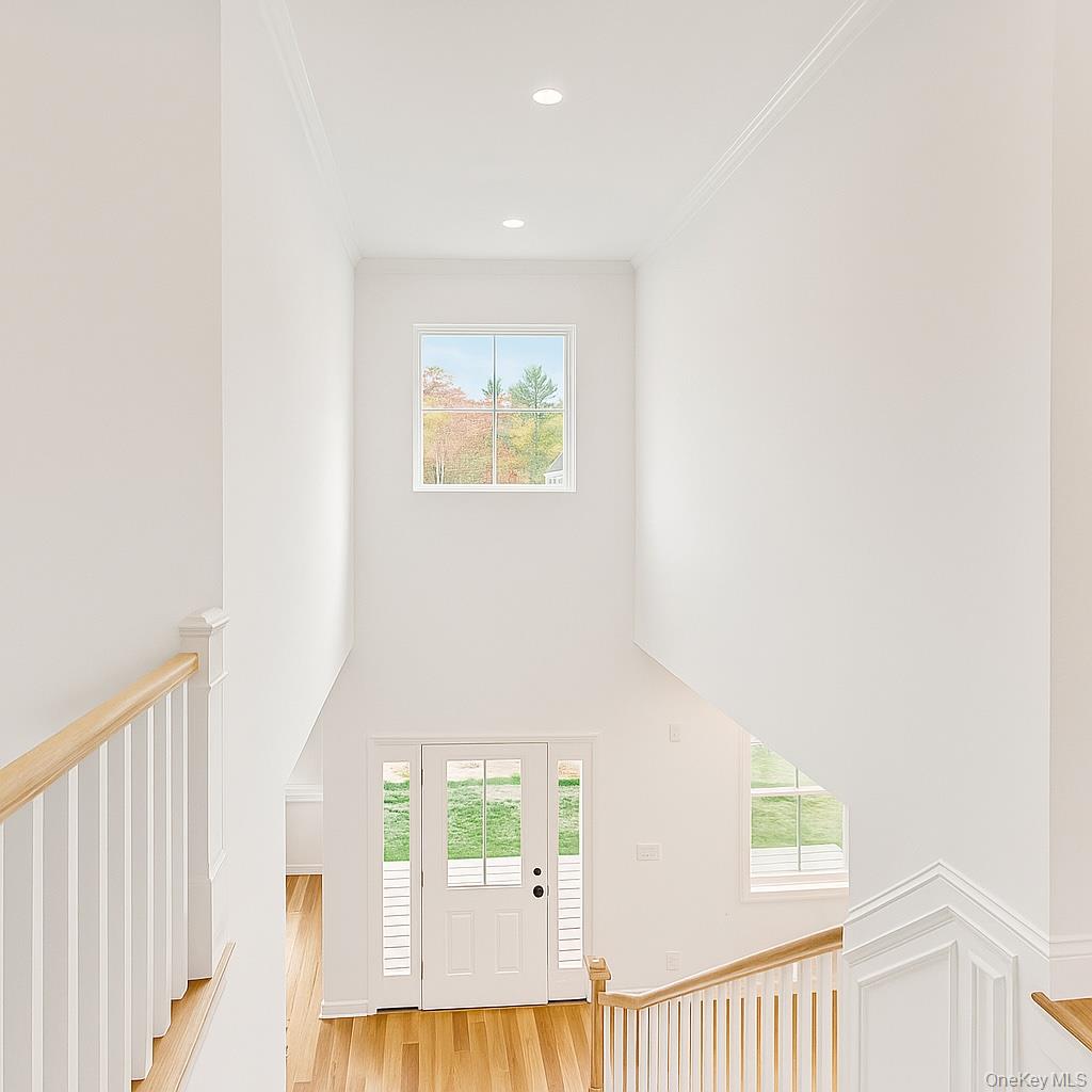 12 Fox Run Court Ridge, NY 11961 - Photo 7 of 11 a view of a hallway with wooden floor and a bathroom