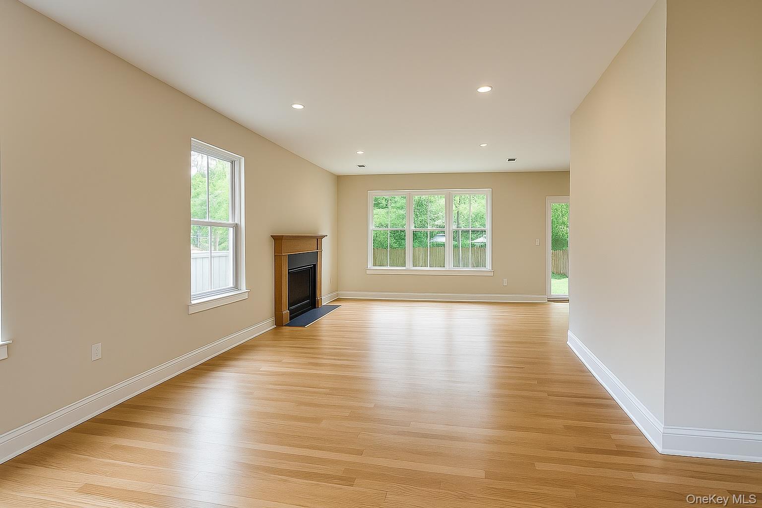 12 Fox Run Court Ridge, NY 11961 - Photo 8 of 11 an empty room with wooden floor and windows