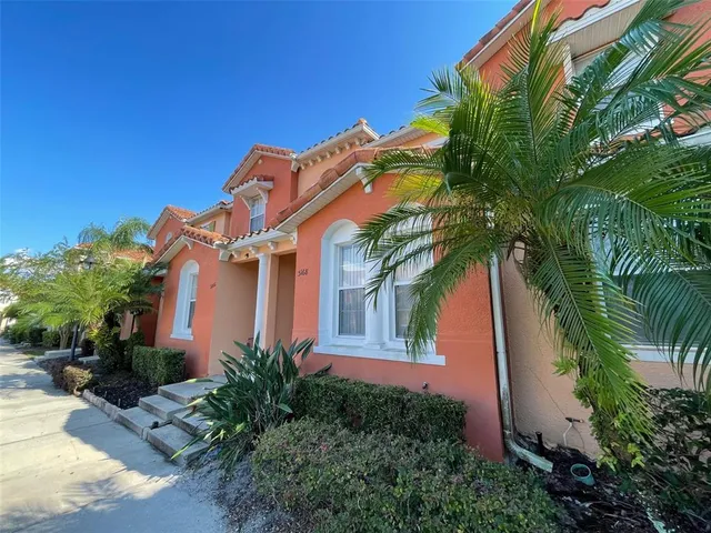a view of a house with a palm tree
