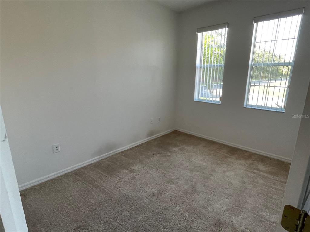 5168 Regatta Drive Kissimmee, FL 34746 - Photo 9 of 12 an empty room with windows