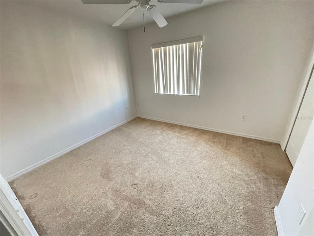 5168 Regatta Drive Kissimmee, FL 34746 - Photo 10 of 12 an empty room with windows