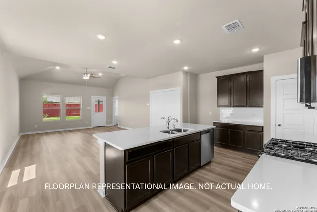 a view of kitchen with sink and wooden floor